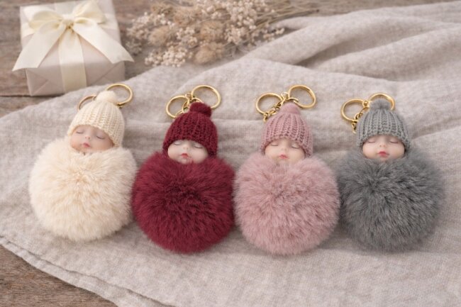 Schl&uuml;sselanh&auml;nger schlafendes Baby mit Fellbommel 12cm creme